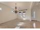 Bright living room with modern lighting and a front door entryway at 42625 W Sandpiper Dr, Maricopa, AZ 85138