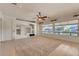 Open concept living space with built-in media center and bright windows at 42625 W Sandpiper Dr, Maricopa, AZ 85138