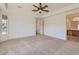 Spacious main bedroom with ceiling fan and ensuite bathroom access, offering comfort and convenience at 42625 W Sandpiper Dr, Maricopa, AZ 85138