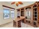 Charming office featuring custom built-ins, a desk, and natural light, ideal for a home workspace at 42625 W Sandpiper Dr, Maricopa, AZ 85138