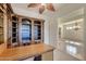 Charming office featuring custom built-ins, a desk, and natural light, ideal for a home workspace at 42625 W Sandpiper Dr, Maricopa, AZ 85138