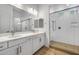 Modern bathroom features double sink vanity, white cabinets, and a glass enclosed shower at 4314 E Bernice St, Gilbert, AZ 85295