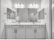 Bright bathroom featuring double sinks, a large mirror, and sleek white cabinetry for modern elegance at 4314 E Bernice St, Gilbert, AZ 85295