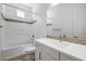 Well-lit bathroom featuring tile accents, a tub, and a modern sink with sleek white cabinetry at 4314 E Bernice St, Gilbert, AZ 85295
