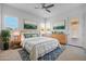 Primary bedroom featuring neutral carpet, fan, a bed with blue accents, and shuttered windows at 4314 E Bernice St, Gilbert, AZ 85295