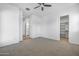 Spacious bedroom includes neutral carpet, ceiling fan, and doorway to bathroom and walk in closet at 4314 E Bernice St, Gilbert, AZ 85295