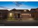 Charming single-story home at dusk with a stone-accented facade, landscaped front yard and an attached two-car garage at 4314 E Bernice St, Gilbert, AZ 85295