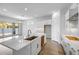 Bright modern kitchen with white cabinets, stone countertops, stainless steel faucet and wood-style flooring at 4314 E Bernice St, Gilbert, AZ 85295