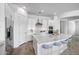 Bright modern kitchen with white cabinets, stone countertops, stainless steel appliances and bar stool seating at 4314 E Bernice St, Gilbert, AZ 85295