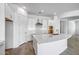 Bright modern kitchen with white cabinets, stone countertops, stainless steel faucet and wood-style flooring at 4314 E Bernice St, Gilbert, AZ 85295
