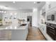Bright modern kitchen with white cabinets, stone countertops, stainless steel appliances and decor at 4314 E Bernice St, Gilbert, AZ 85295