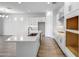 Bright modern kitchen with white cabinets, stone countertops, stainless steel faucet and wood-style flooring at 4314 E Bernice St, Gilbert, AZ 85295