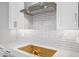 Modern kitchen backsplash with white subway tile, white countertop and stainless steel range hood at 4314 E Bernice St, Gilbert, AZ 85295