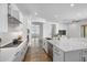 Bright modern kitchen with white cabinets, stone countertops, stainless steel appliances and decor at 4314 E Bernice St, Gilbert, AZ 85295