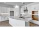 Modern kitchen with white cabinets, stainless steel appliances, a large island, and tiled backsplash at 4314 E Bernice St, Gilbert, AZ 85295