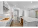 Bright modern kitchen with white cabinets, stone countertops, stainless steel faucet and wood-style flooring at 4314 E Bernice St, Gilbert, AZ 85295
