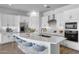 Modern kitchen with white cabinets, a large island, and pendant lighting, complete with seating and appliances at 4314 E Bernice St, Gilbert, AZ 85295