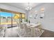 Virtual staging of dining area showing table and chairs in bright living room with hardwood floors at 4314 E Bernice St, Gilbert, AZ 85295