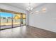 Bright living room featuring hardwood floors, a modern chandelier, and sliding glass doors to backyard at 4314 E Bernice St, Gilbert, AZ 85295