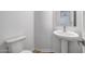 Bright powder room featuring modern fixtures, a sleek pedestal sink, and a neutral color palette at 4314 E Bernice St, Gilbert, AZ 85295