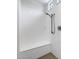 White shower stall with built-in bench and sleek chrome shower fixture; simple and modern at 4314 E Bernice St, Gilbert, AZ 85295
