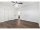 Bedroom featuring wood floors, closet, a ceiling fan, and an ensuite bath at 48 S Catalina St, Gilbert, AZ 85233