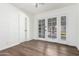 Sunlit bedroom with wood floors, large windows and a glass patio door at 48 S Catalina St, Gilbert, AZ 85233