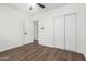 Bedroom featuring wood floors, closet, a ceiling fan, and an ensuite bath at 48 S Catalina St, Gilbert, AZ 85233
