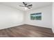 Spacious bedroom featuring wood flooring, a modern ceiling fan, and a bright window at 48 S Catalina St, Gilbert, AZ 85233