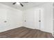 Bedroom with wood floors, three doors, and a ceiling fan at 48 S Catalina St, Gilbert, AZ 85233