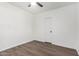 Simple bedroom features white walls and laminate wood flooring with access to door at 48 S Catalina St, Gilbert, AZ 85233