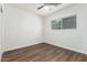 Neutral bedroom with wood-look floors, ceiling fan and large window at 48 S Catalina St, Gilbert, AZ 85233