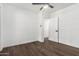 Bedroom with wood floors, a ceiling fan, and an open doorway to another room at 48 S Catalina St, Gilbert, AZ 85233