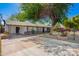 Charming home with ample driveway, shade tree, and a well-maintained front yard landscape at 48 S Catalina St, Gilbert, AZ 85233