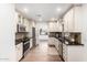 Updated kitchen featuring stainless steel appliances, custom cabinets, and plenty of counter space at 48 S Catalina St, Gilbert, AZ 85233