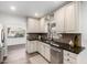 Updated kitchen with stainless steel appliances, stone countertops and tile backsplash at 48 S Catalina St, Gilbert, AZ 85233