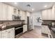 Updated kitchen featuring stainless steel appliances, custom cabinets, and plenty of counter space at 48 S Catalina St, Gilbert, AZ 85233