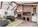 Bright living room featuring exposed wood beams, brick fireplace, and comfortable seating at 48 S Catalina St, Gilbert, AZ 85233