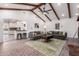 Spacious living room with exposed wood beams, brick floor and comfortable seating area at 48 S Catalina St, Gilbert, AZ 85233