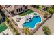 Aerial view of a backyard featuring a pool, spa, lounge area, and outdoor kitchen at 5051 S Moccasin Trl, Gilbert, AZ 85298