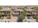 Aerial view of a well-landscaped two-story home with a brick-paved driveway and a two-car garage at 5051 S Moccasin Trl, Gilbert, AZ 85298