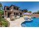 An inviting backyard with a pool, spa, lounge chairs, and a cozy seating area with a fire pit for relaxation at 5051 S Moccasin Trl, Gilbert, AZ 85298