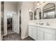 Bright bathroom features a double vanity with white cabinets and a walk-in closet at 5051 S Moccasin Trl, Gilbert, AZ 85298