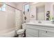 A well-lit bathroom with a shower-tub combination and a vanity with storage at 5051 S Moccasin Trl, Gilbert, AZ 85298
