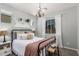 Bedroom featuring a metal bed frame, plush bedding, and natural light streaming through the window at 5051 S Moccasin Trl, Gilbert, AZ 85298