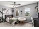 Cozy bedroom with a ceiling fan, ample natural light, and stylish decor at 5051 S Moccasin Trl, Gilbert, AZ 85298