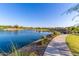 Beautiful community lake with a walking path and lush landscaping, offering a serene and picturesque view at 5051 S Moccasin Trl, Gilbert, AZ 85298