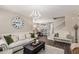 Bright living room featuring comfortable seating, decorative clock, dining area, and staircase at 5051 S Moccasin Trl, Gilbert, AZ 85298