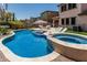 Inviting backyard pool with a built-in spa, lounge chairs, and lush landscaping at 5051 S Moccasin Trl, Gilbert, AZ 85298