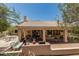 Outdoor entertaining area features a covered patio with a built-in grill and ample seating at 6010 E Languid Ln, Carefree, AZ 85377
